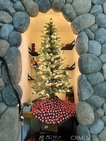 Experience Christmas next to a stone fireplace with a roaring fire