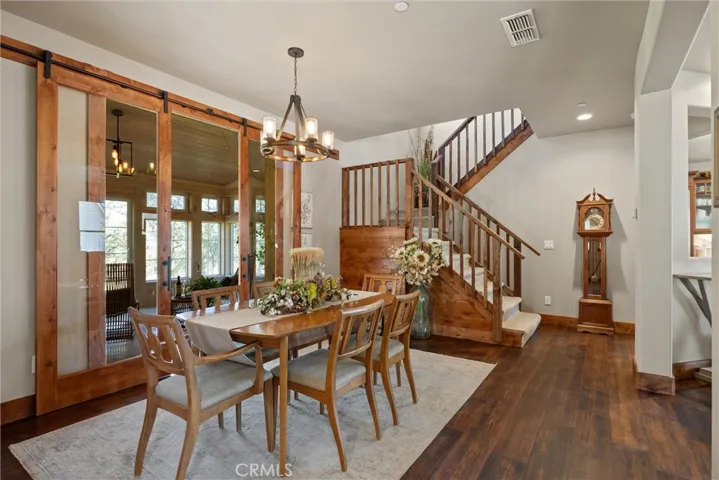 Dining room with glass barn doors into the sunroom