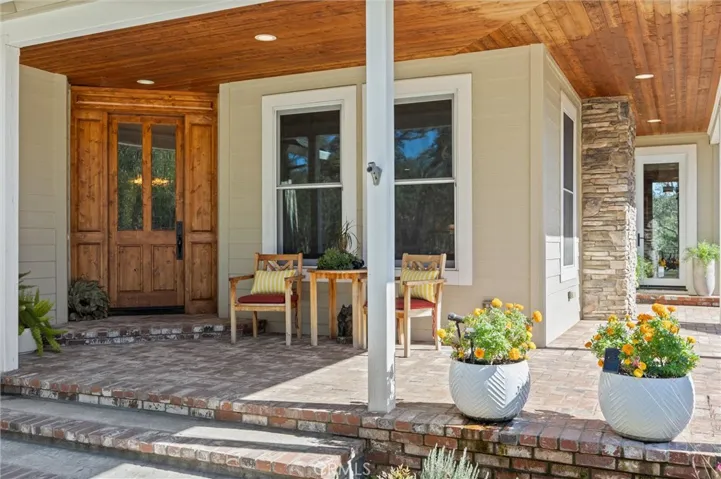 Front porch with glass door into kitchen nook.