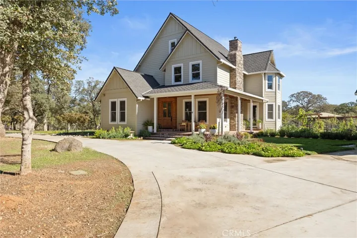 House entrance with covered porch and brick patio