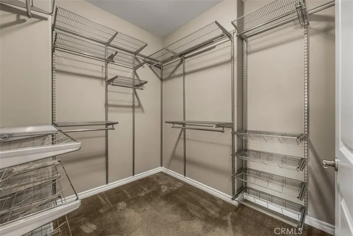 Walk in closet in primary bedroom