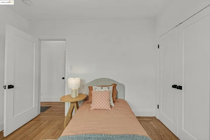 Bedroom featuring light wood finished floors and ornamental molding
