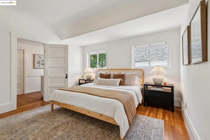 Bedroom with wood finished floors and baseboards