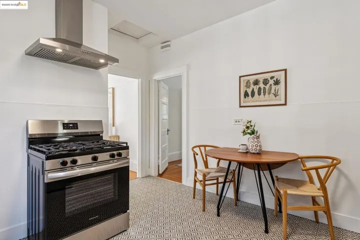 Kitchen featuring stainless steel gas stove and extractor fan