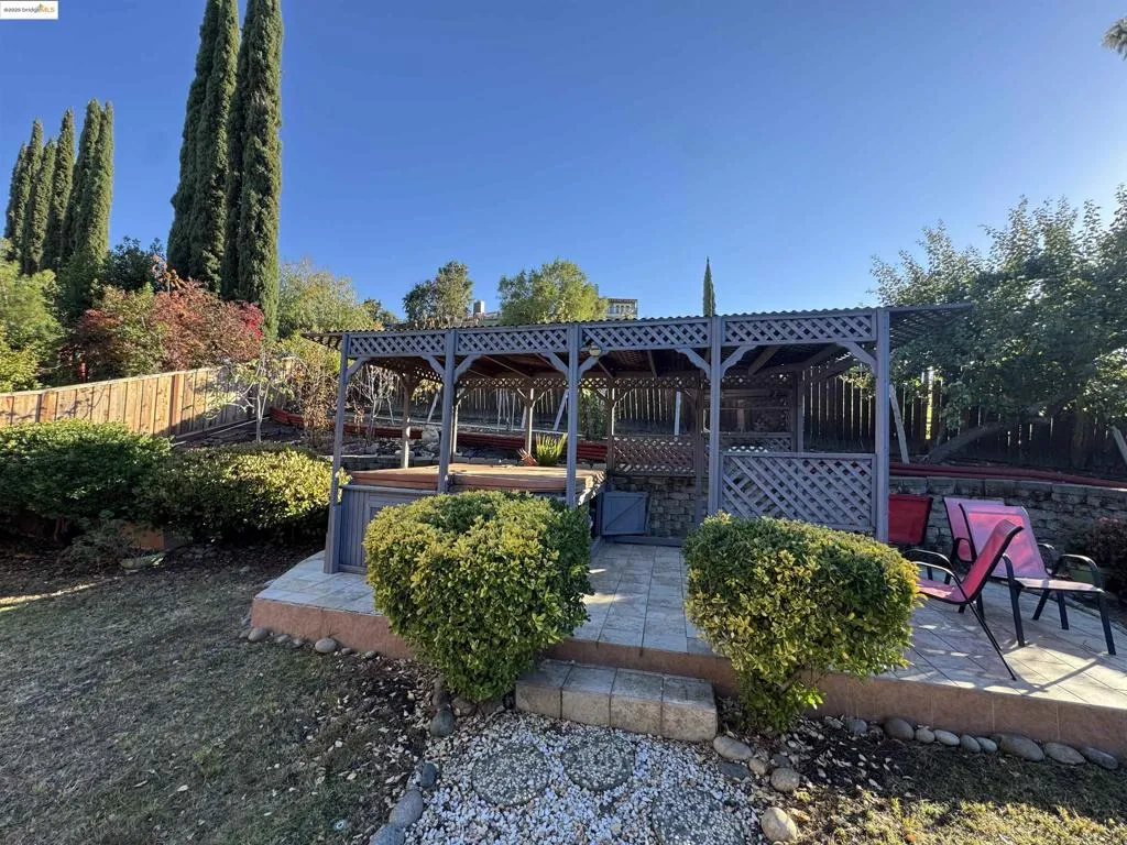 Rear view of house with a patio and a gazebo