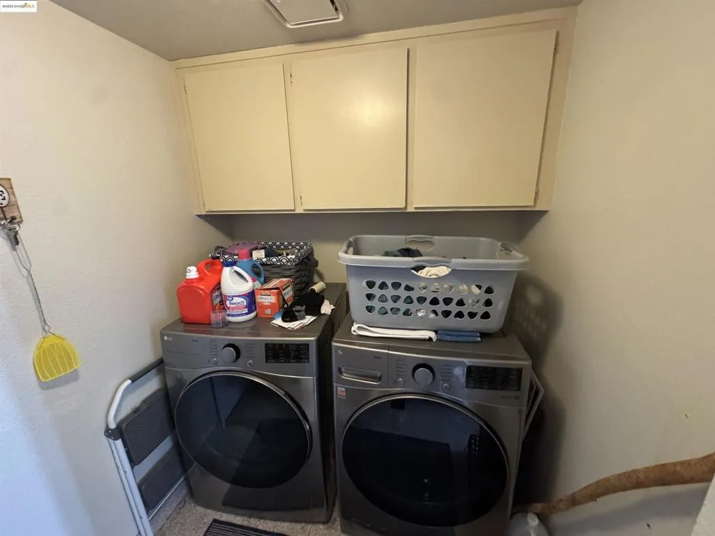 Laundry room with cabinet space and independent washer and dryer