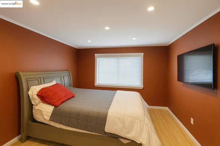 Bedroom with ornamental molding, wood finished floors, and recessed​​‌​​​​‌​​‌‌​​‌​​​‌‌​​​‌​​‌‌​​‌‌​​‌‌​​​​ lighting
