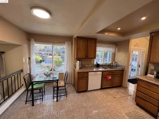 Kitchen with dishwasher and brown cabinets