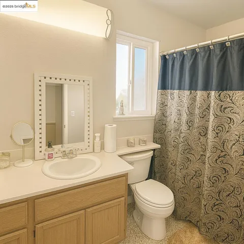 Full bathroom with vanity and a shower with curtain