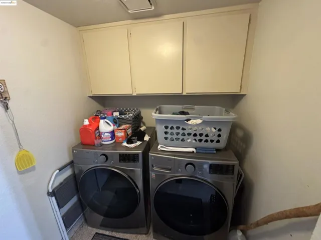 Laundry room with cabinet space and independent washer and dryer