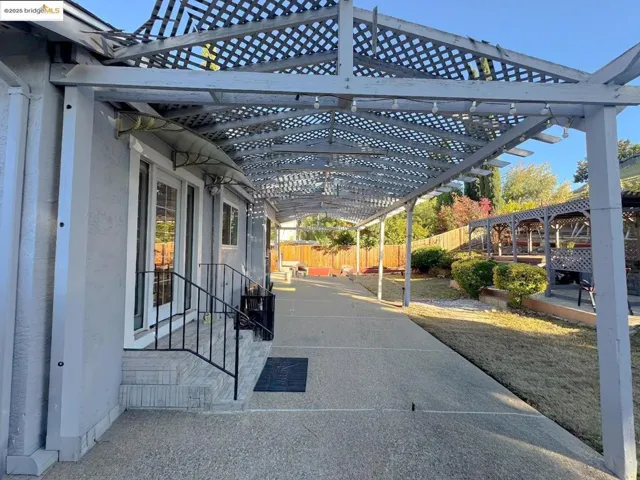Fenced backyard featuring a pergola and a patio