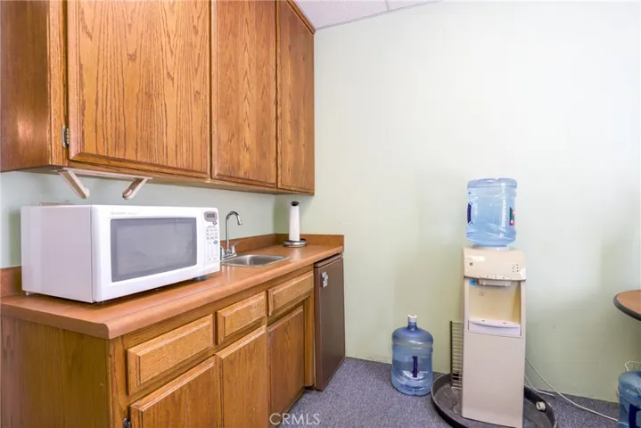 Break room has cabinets and a sink area.