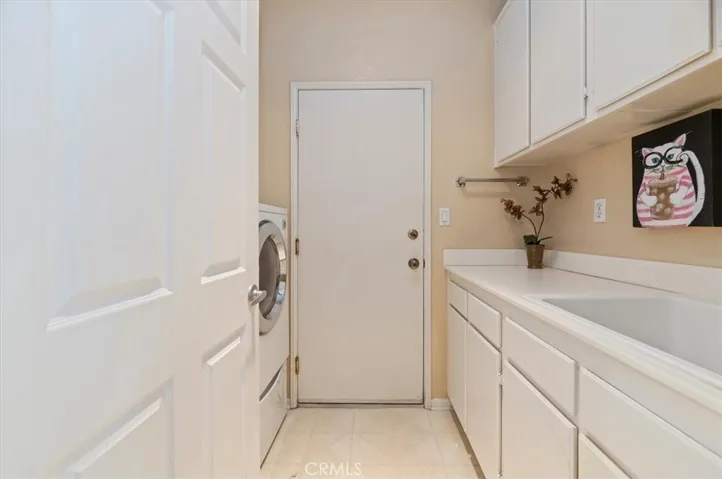 Laundry room with deep sink and storage cabinets