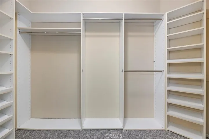 Primary - Walk-in-closet with custom fixtures