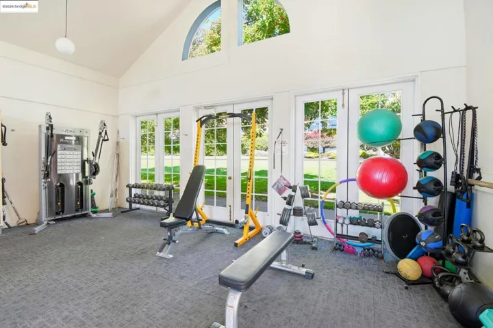 Exercise room with high vaulted ceiling