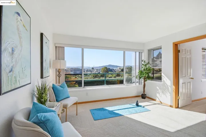 Sitting room with healthy amount of natural light, carpet, and a mountain view