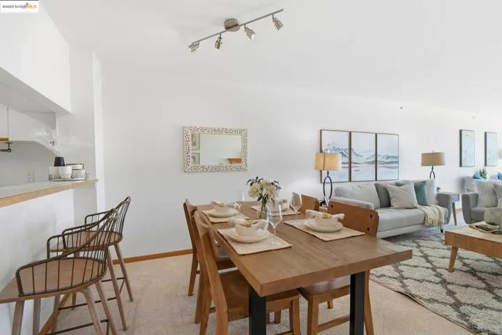 Dining area with light carpet and baseboards