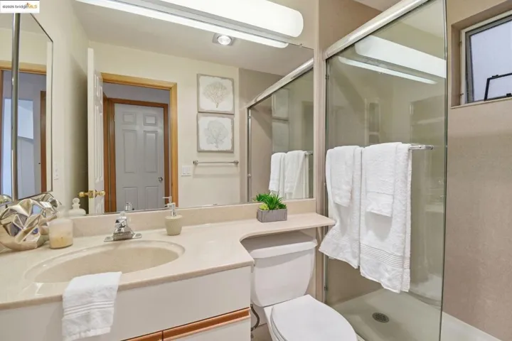 Bathroom featuring a stall shower and vanity