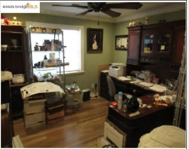 Office featuring ceiling fan and dark wood-style floors