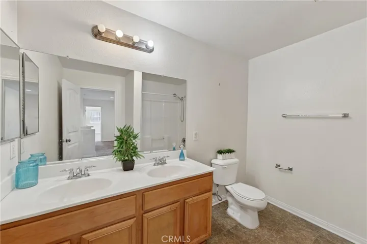 Full upstairs bathroom with dual vanities — perfect for guests or family