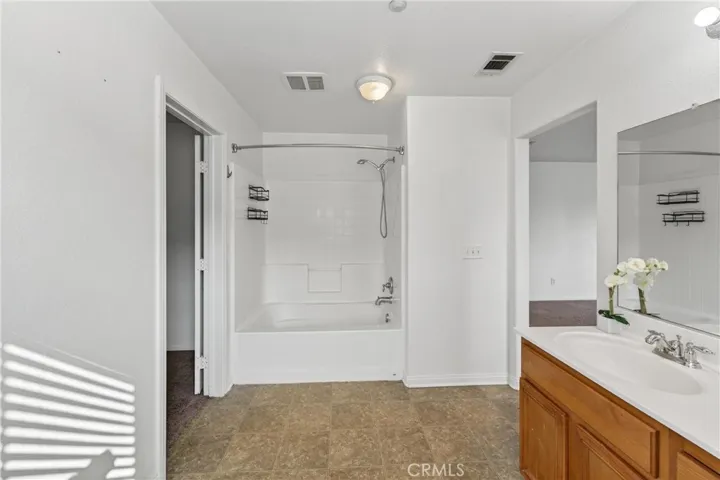 Primary bathroom includes dual sinks, soaking tub, and shower