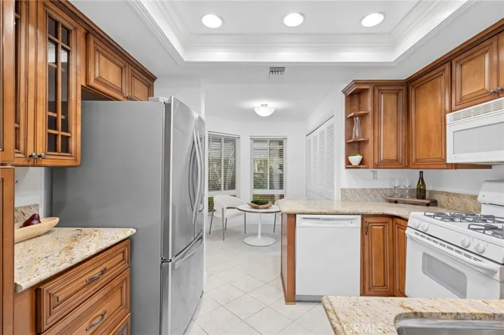 The upgraded kitchen offers ample cabinet space, modern appliances, and a convenient layout