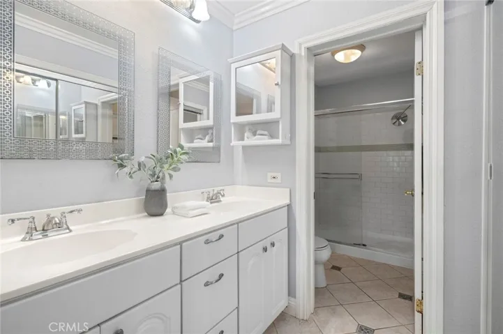 and includes an en-suite dual vanity, a mirrored walk-in closet and walk-in shower