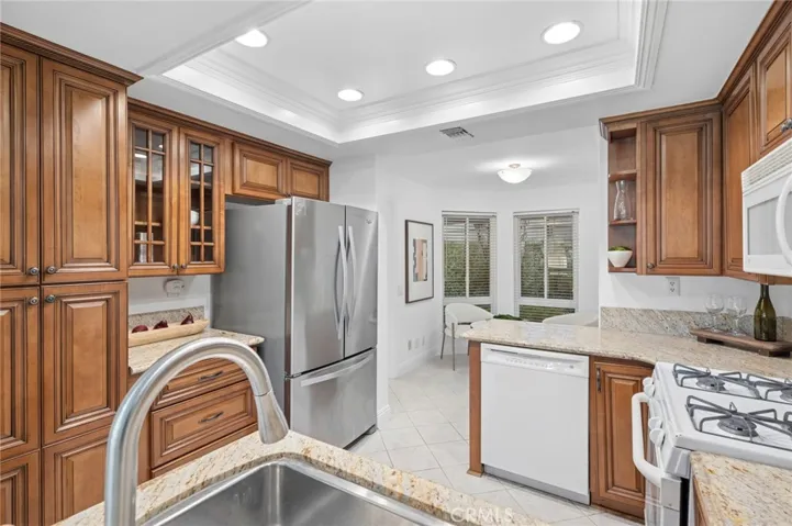 The kitchen cabinets are custom maple and the counters are granite