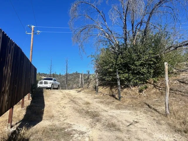 Owner says this road is on his property but left it open for neighbor access .He has barb wire fence side