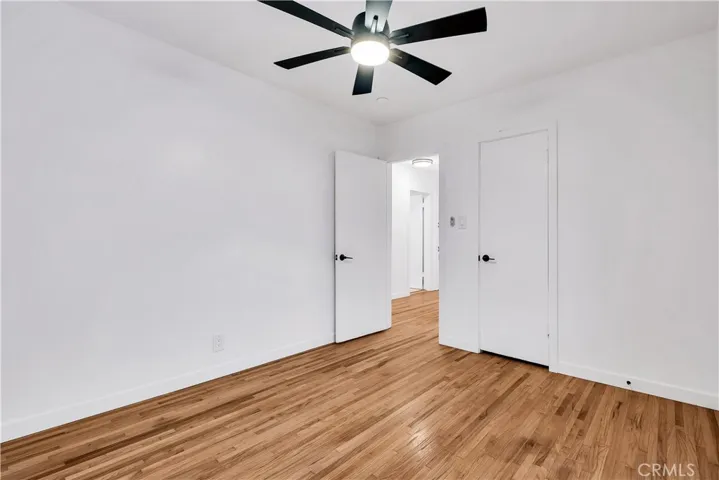 Front Bedroom #3 with beautiful refinished original hardwood floors, new baseboards & new ceiling fan.
