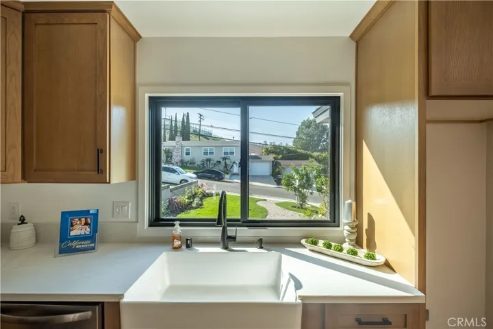 Enjoy a picturesque view of the front yard from your kitchen window, where natural light pours in.