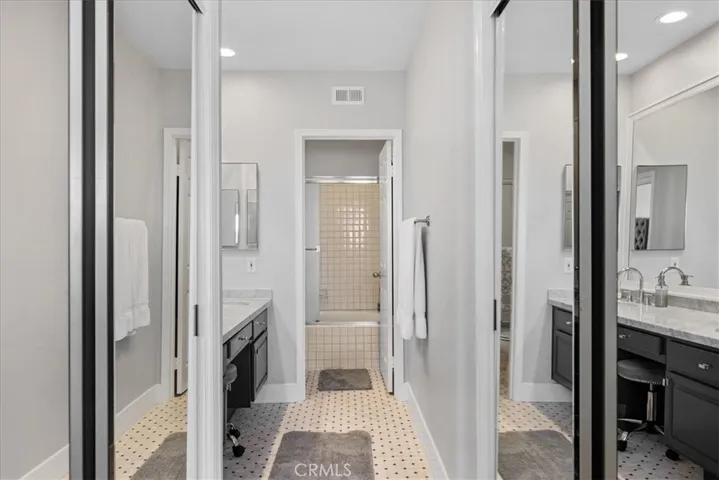 Mirrored closets - one is a walk-in with built ins on the right side.
