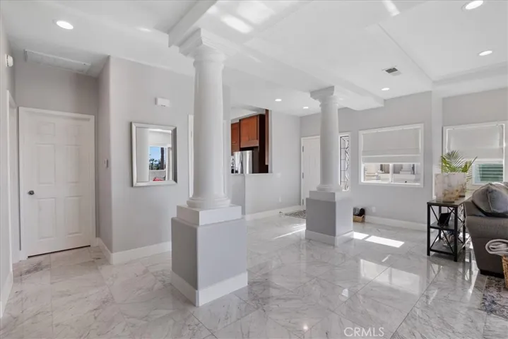 From dining room facing entrance and kitchen. Door is to the guest bedroom on the left.