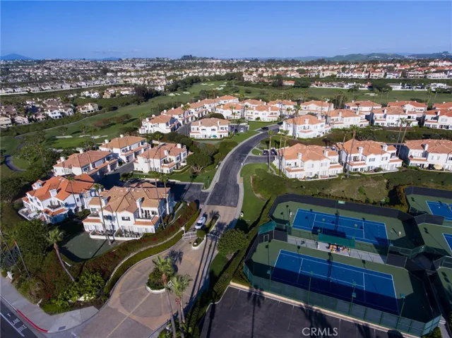 Aerial views of Tennis Villas overlooking Tennis Courts and gated entrance just off of Niguel Road in Monarch Beach.
