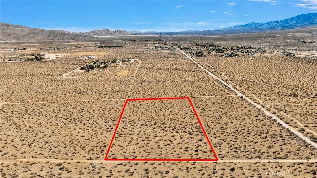 Located near other home sites. Utility poles at the road pictured at the right (south).