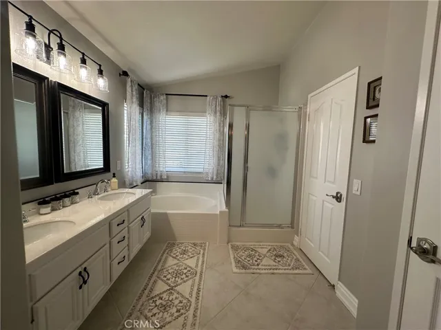 dual sinks Master bath with walk in closet separate shower and tub custom mirror and light fixtures  and plumbing fixtures