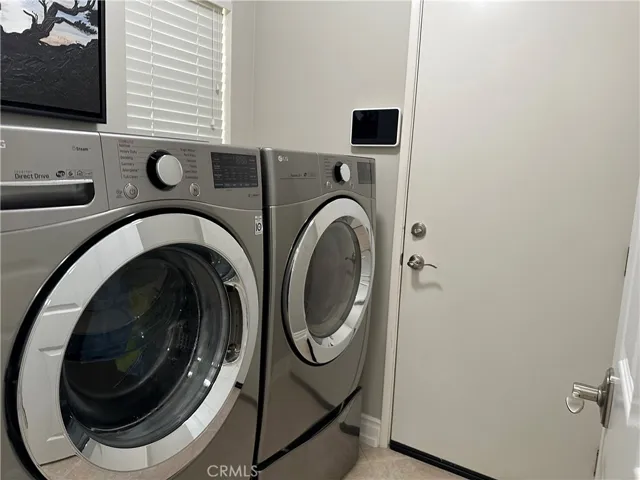  separate Laundry room  with cabinet  gas washer and dryer hook up large size  and entry to garage