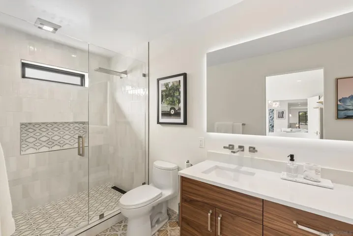 Serene modern baths with layered lighting that feels like a private spa.