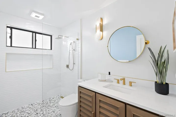 Serene modern baths with layered lighting that feels like a private spa.