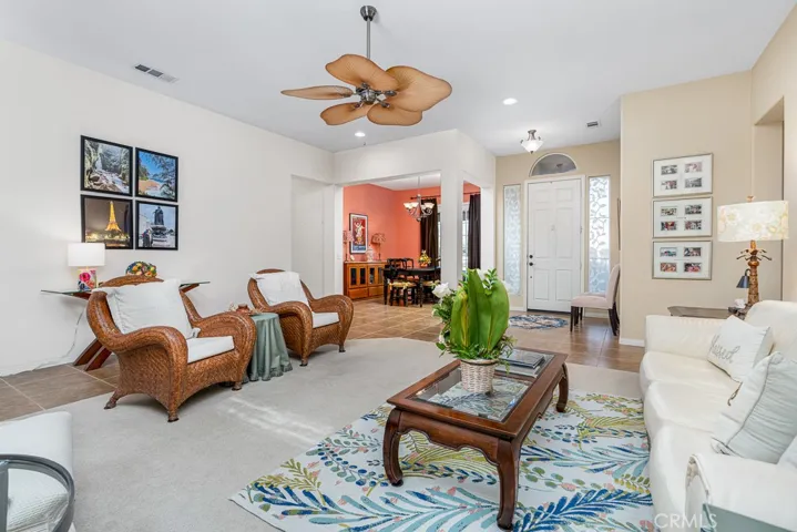 The living area offers ample room to entertain, featuring an effortless connection to the dining space and abundant natural light that sets the perfect mood for any occasion.
