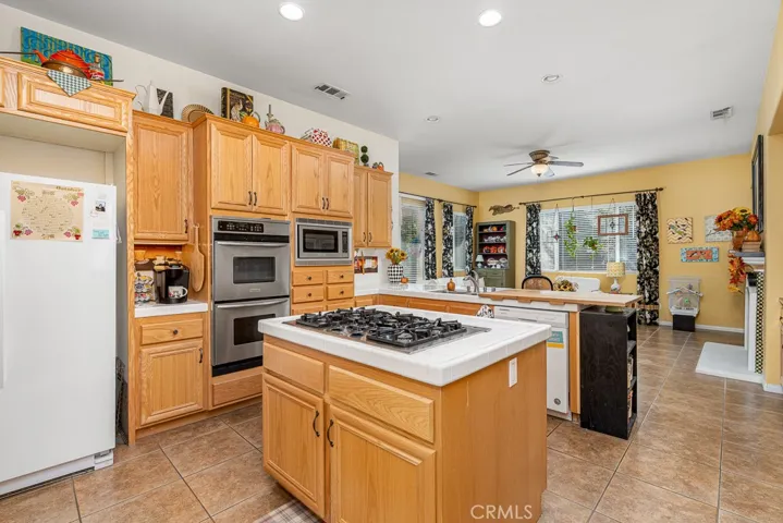 The center island, complete with a cooktop and double ovens, creates an inviting space for crafting and sharing delicious meals.

Would you like me to merge this with your earlier sentences into a single, polished home description paragraph?