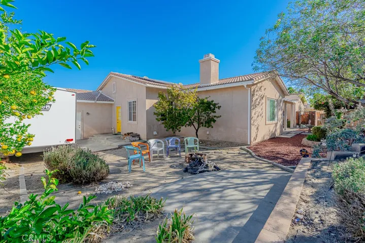 The side of the home offers convenient RV parking, complete with a cozy sitting area perfect for relaxing by a firepit.
