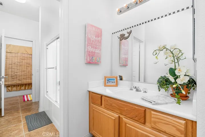 A Jack and Jill bathroom offers shared convenience for two bedrooms, complete with a full bath, tub/shower combination, and a spacious vanity.