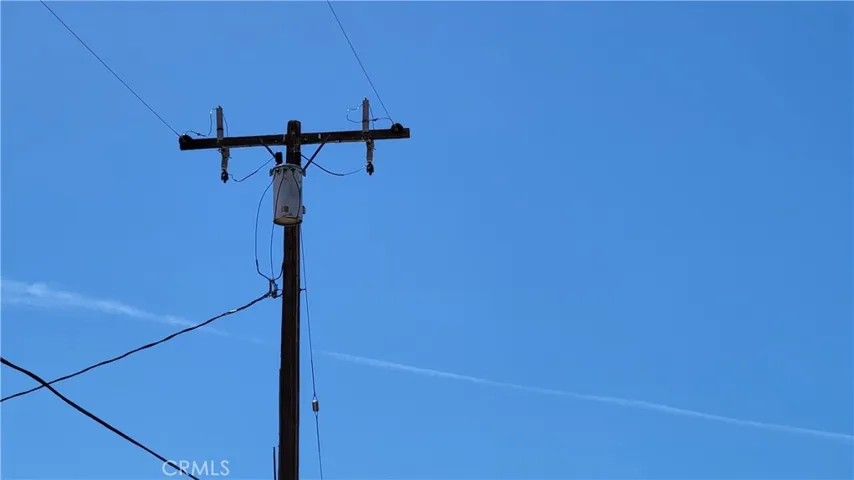 UTILITY POWER LINE AND POWER CABLES DIRECTLY ACROSS STREET OF VACANT LOT