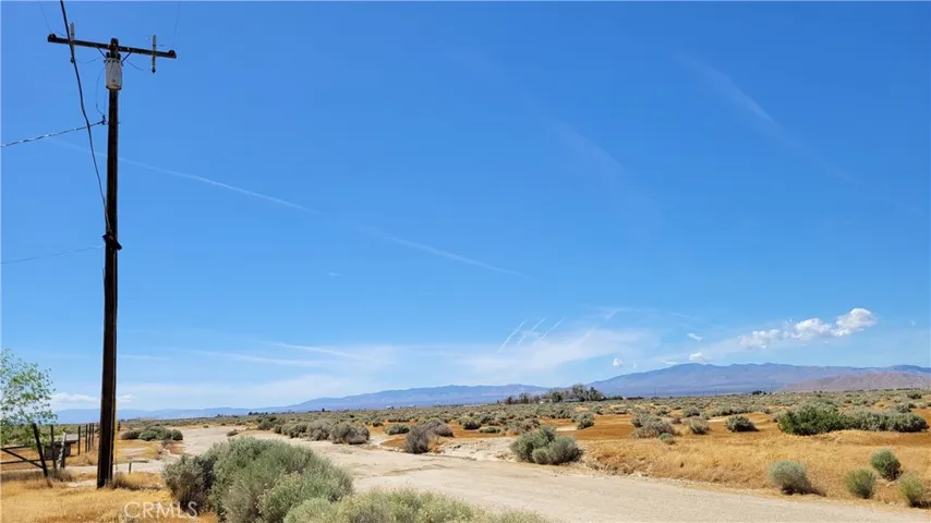 POWER POLE AND POWER LINES DIRECTLY ACROSS FIVE ACRE VACANT LOT
