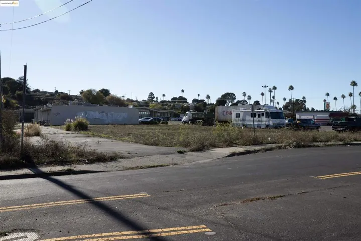 View of asphalt street featuring sidewalks and curbs