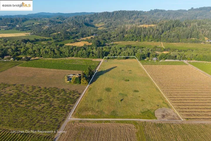 View of rural area with property boundaries highlighted and a heavily wooded area