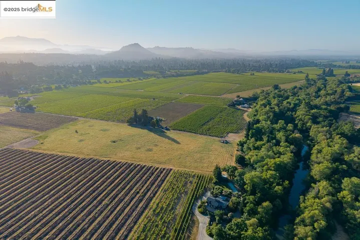 Aerial view of property's location featuring abundant farmland, mountains, and rural landscape