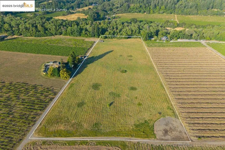 View of rural area featuring property boundaries highlighted and rows of crops