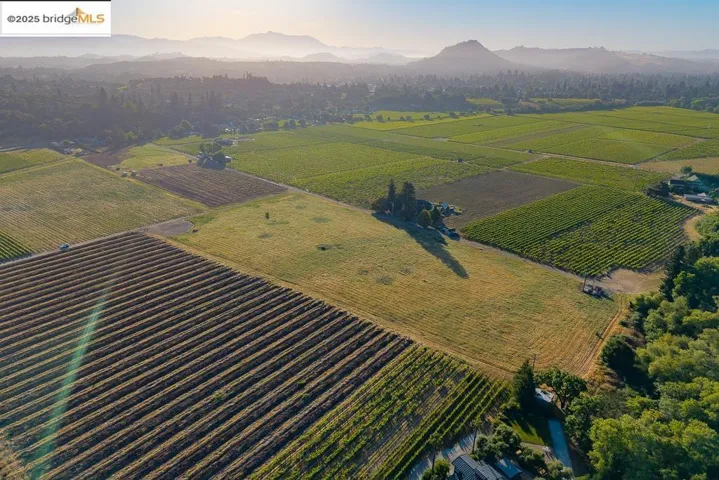 View of rural area featuring a mountain backdrop and farmland